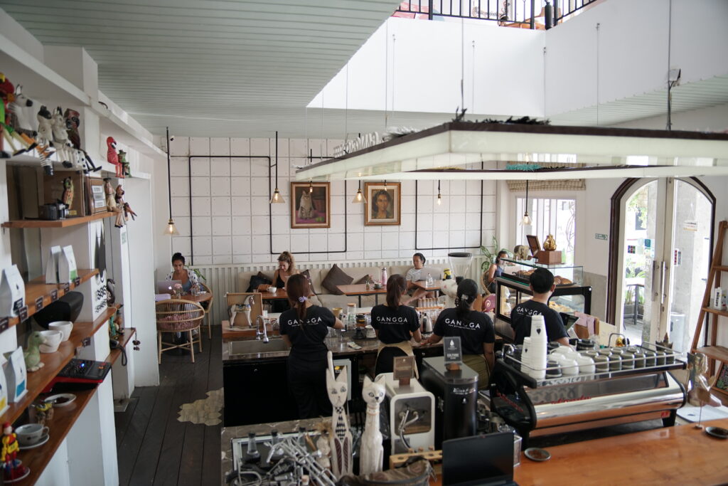 people enjoying coffee inside a relaxed cafe setting in Bali