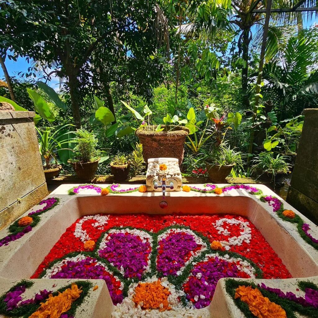 Romantic flower bath setup in a private tropical villa, surrounded by lush greenery and peaceful garden ambiance in Bali.